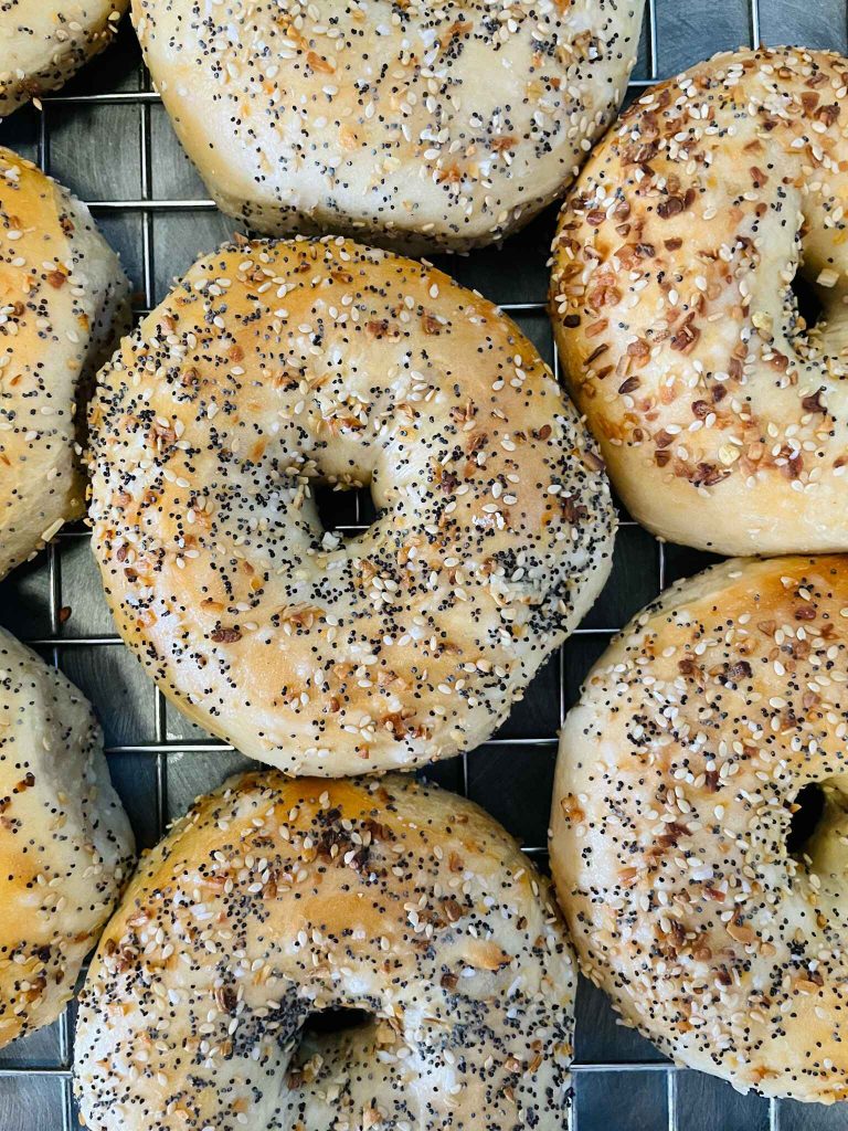 A bunch of fresh sesame bagels.