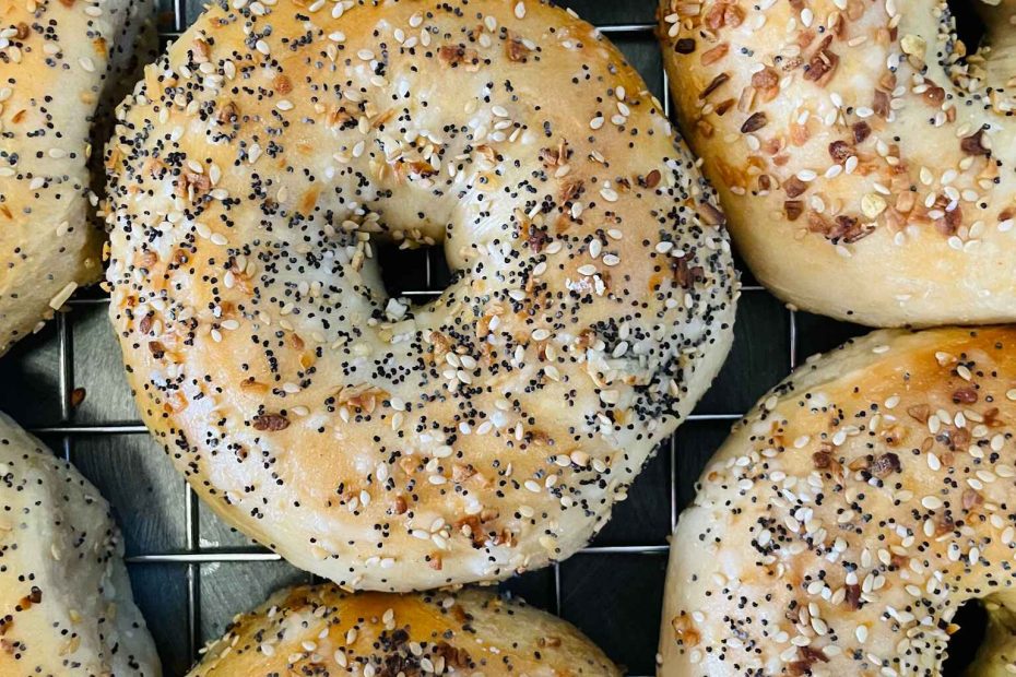 A bunch of fresh sesame bagels.