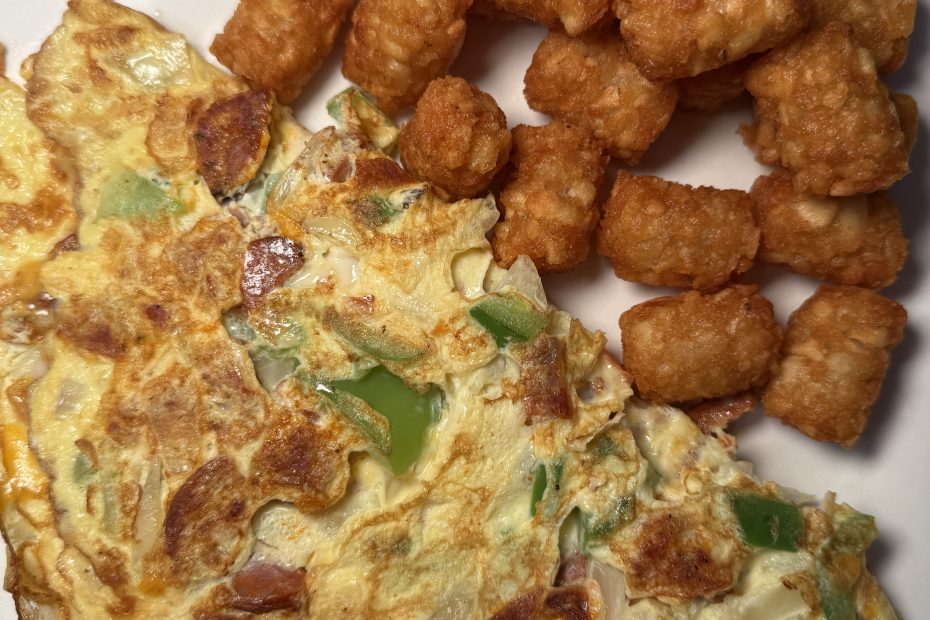 Fresh veggie omelet with crispy tater tots served at Fast Bagel, New Jersey – the perfect post-Halloween breakfast idea