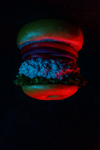 Upside-down bagel glowing in eerie red and blue light, inspired by Stranger Things’ Upside Down vibe.