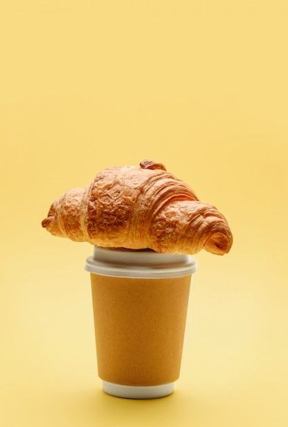 Croissant placed on top of coffee