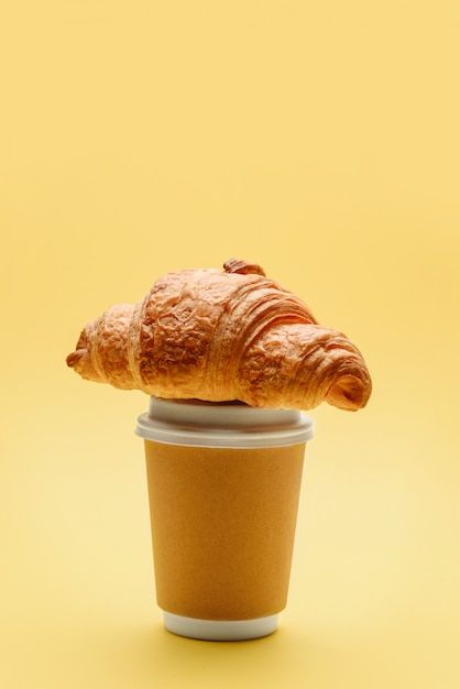 Croissant placed on top of coffee