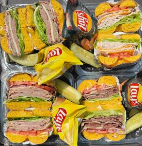 Individual boxed lunch and breakfast catering Central NJ with deli bagel sandwiches, chips, and pickles from Fast Bagel