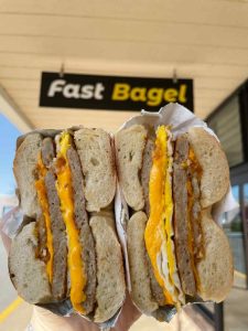 Loaded two-egg sausage and cheese breakfast sandwiches Central NJ served under the Fast Bagel storefront sign