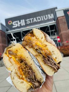 Fast Bagel sandwich with SHI Stadium in the background