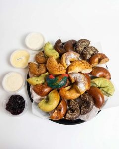 Bagel catering for groups with assorted bagels, butter and cream cheese spreads.