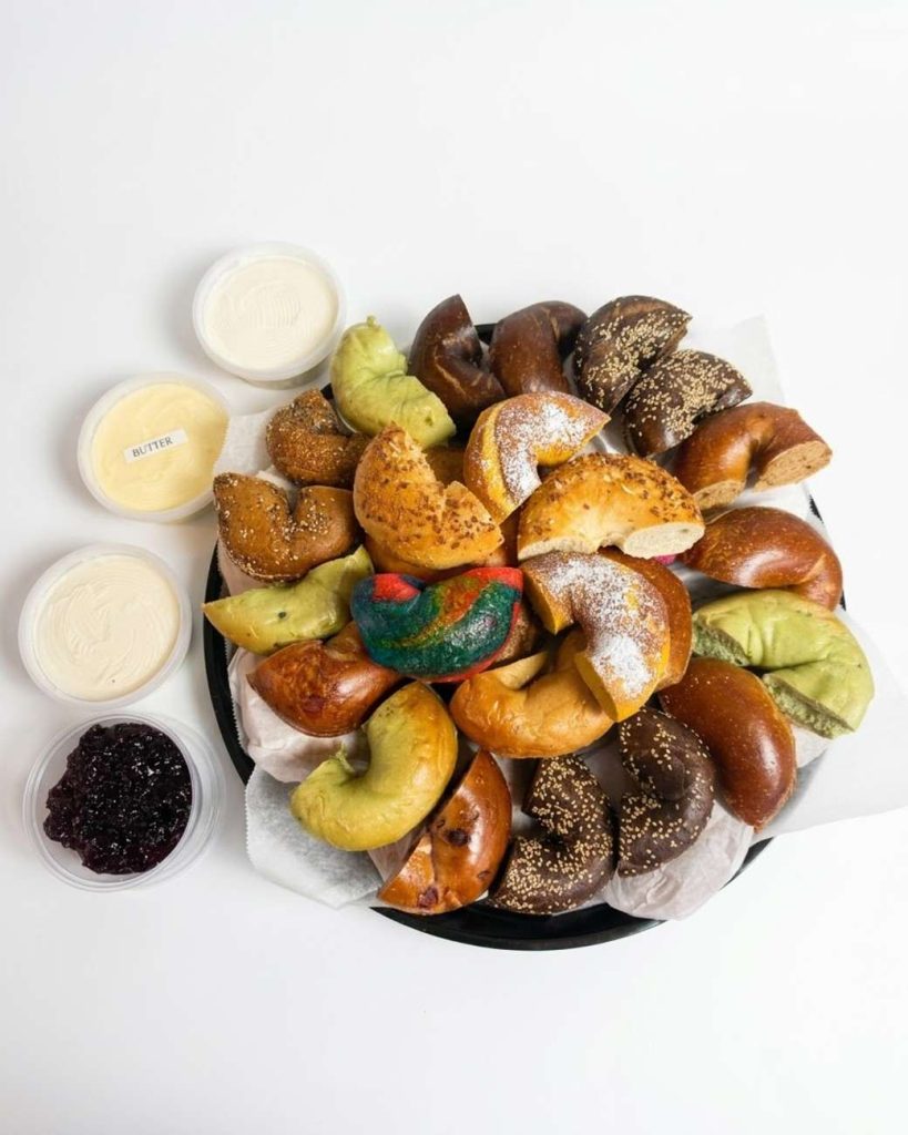 Bagel catering for groups with assorted bagels, butter and cream cheese spreads.