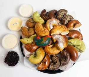 Bagel catering for groups with assorted bagels, butter and cream cheese spreads.